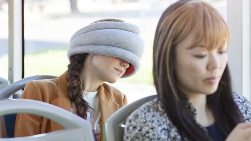 A Lady Having A Power Nap On A Bus With Ostrich Pillow