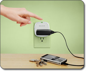 F7C009 Conserve Socket Energy Saving Outlet with a cellphone