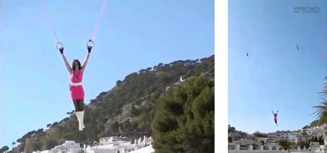 Woman Hanging In Air With Two Toy Helicopters